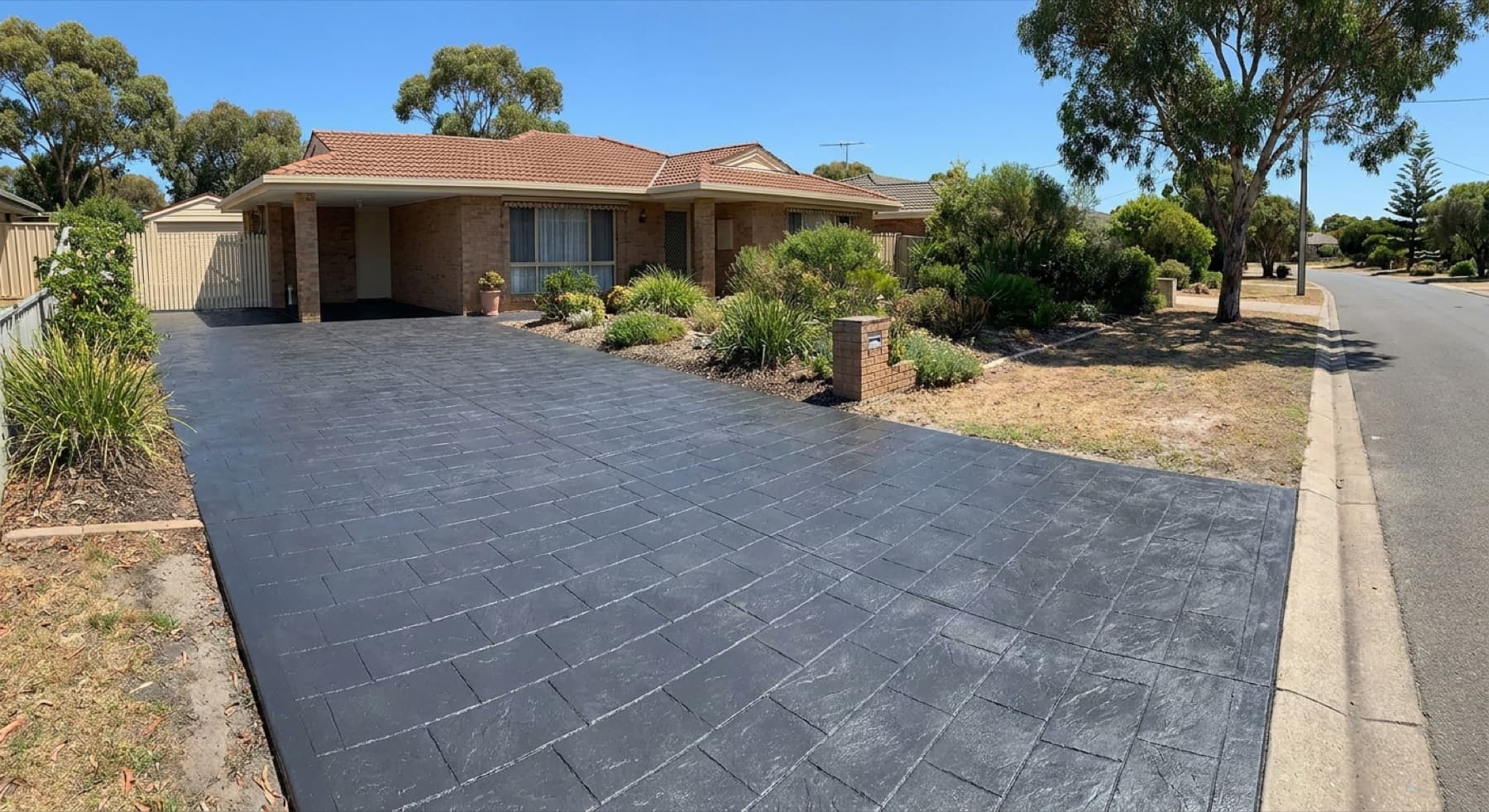 A stencil driveway restored with a fresh, even charcoal colour seal