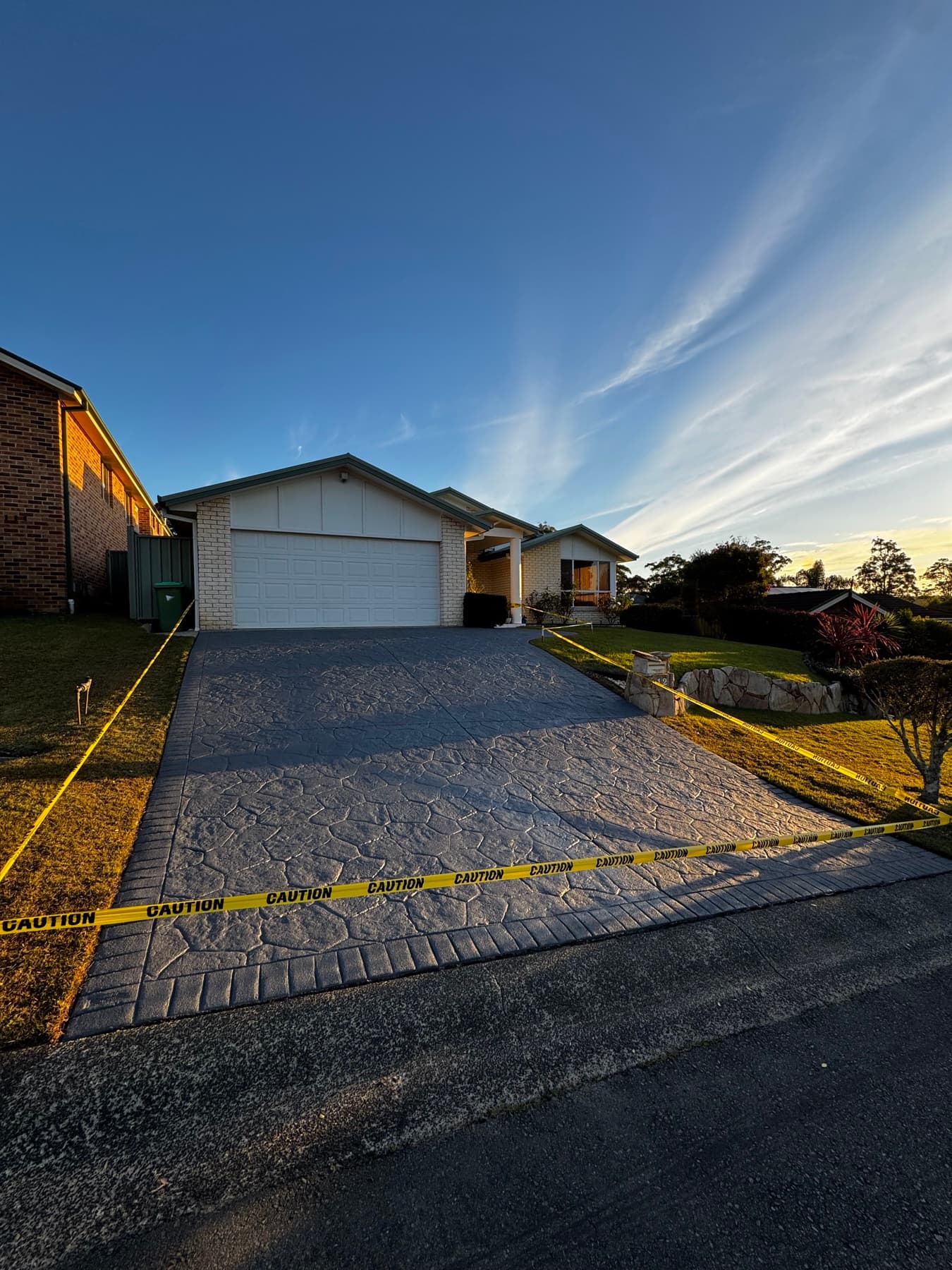 A freshly resealed charcoal stencil driveway on the Central Coast